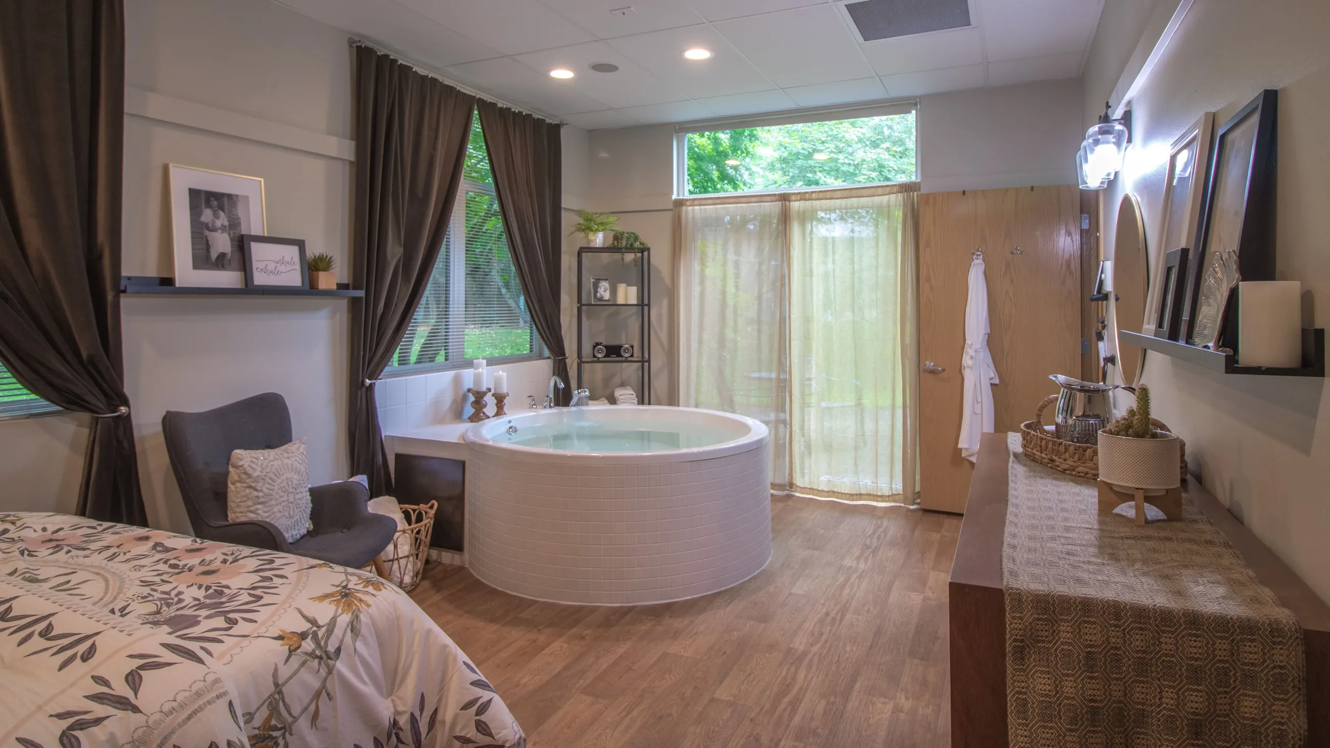 A birth suite at The Birthing Inn with a round water-birth tub beneath tall windows